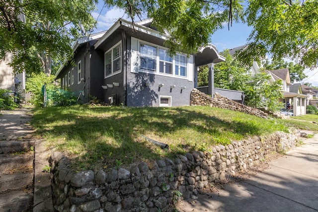 207 Smith Ave, Rockford, IL 61107 - view of home's exterior featuring stucco siding and a lawn