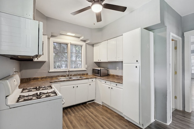 207 Smith Ave, Rockford, IL 61107 - kitchen featuring gas range gas stove, stainless steel microwave, dark countertops, and dark wood finished floors