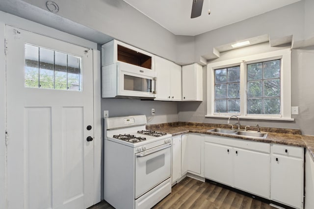 207 Smith Ave, Rockford, IL 61107 - kitchen with white appliances, dark countertops, white cabinetry, dark wood-style flooring, and ceiling fan