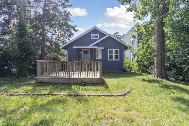 207 Smith Ave, Rockford, IL 61107 - rear view of property featuring a wooden deck, a lawn, and stucco siding