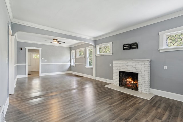 207 Smith Ave, Rockford, IL 61107 - unfurnished living room featuring plenty of natural light, a fireplace, crown molding, wood finished floors, and a ceiling fan