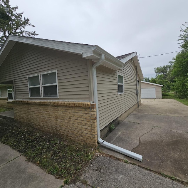 4428 Virginia Ave, Rockford, IL 61101 - view of home's exterior featuring brick siding, a detached garage, and an outbuilding