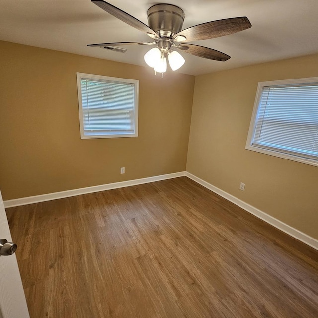 4428 Virginia Ave, Rockford, IL 61101 - empty room featuring healthy amount of natural light, wood finished floors, and a ceiling fan