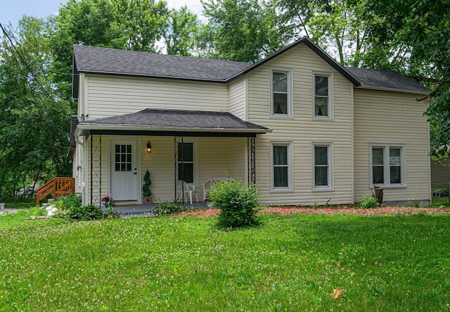 2431 Sandy Hollow Rd, Rockford, IL 61109 - traditional-style home featuring a front yard, a porch, and roof with shingles