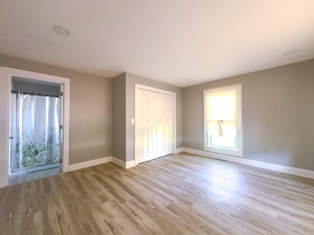 2431 Sandy Hollow Rd, Rockford, IL 61109 - unfurnished bedroom featuring light wood finished floors and a closet