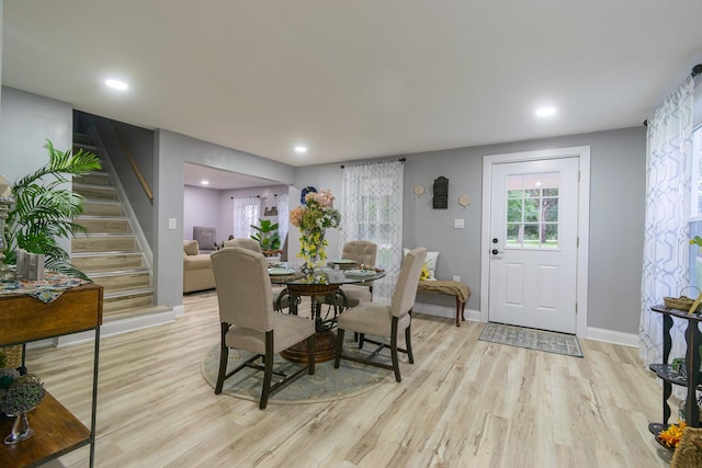 2431 Sandy Hollow Rd, Rockford, IL 61109 - dining room with light wood finished floors, stairs, and recessed lighting