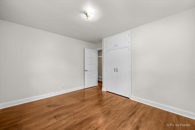 218 N Berteau Ave, Bartlett, IL 60103 - unfurnished bedroom with wood finished floors and a closet