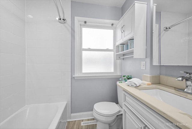 218 N Berteau Ave, Bartlett, IL 60103 - full bath featuring vanity, tub / shower combination, and wood finished floors