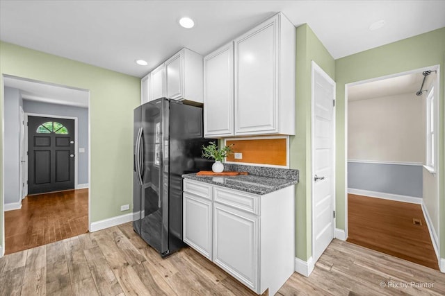 218 N Berteau Ave, Bartlett, IL 60103 - kitchen with freestanding refrigerator, white cabinetry, light wood-type flooring, recessed lighting, and dark stone counters