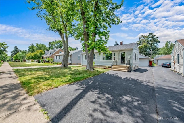 218 N Berteau Ave, Bartlett, IL 60103 - view of front facade with a front yard, an outbuilding, a garage, and a chimney