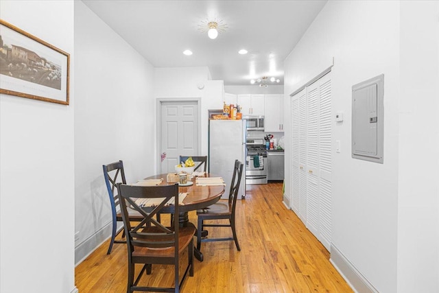 4855 N Springfield Ave Unit 3, Chicago, IL 60625 - dining room featuring electric panel, light wood-type flooring, and recessed lighting