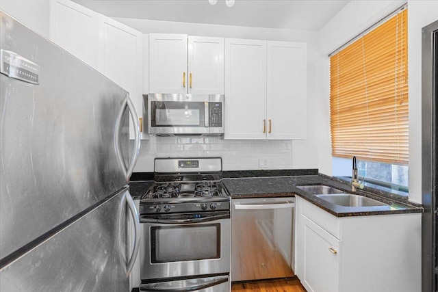 4855 N Springfield Ave Unit 3, Chicago, IL 60625 - kitchen with appliances with stainless steel finishes, white cabinetry, tasteful backsplash, and dark stone countertops