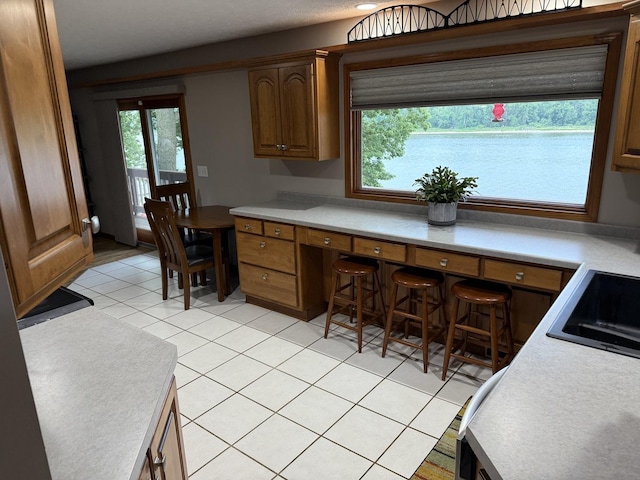 127 S Front St, Hennepin, IL 61327 - kitchen featuring light countertops, light tile patterned floors, and built in study area
