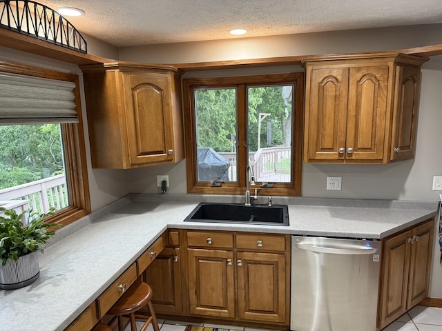 127 S Front St, Hennepin, IL 61327 - kitchen featuring dishwasher, brown cabinets, light countertops, and a textured ceiling
