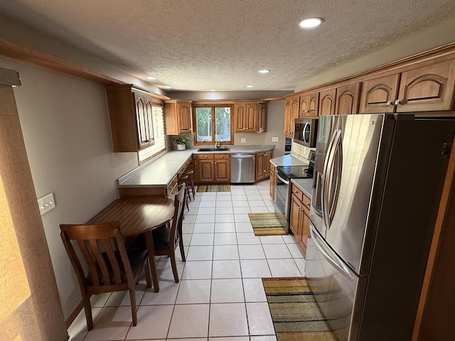 127 S Front St, Hennepin, IL 61327 - kitchen featuring stainless steel appliances, brown cabinetry, light countertops, recessed lighting, and a textured ceiling