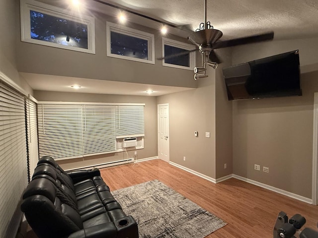127 S Front St, Hennepin, IL 61327 - living area with wood finished floors, cooling unit, ceiling fan, a high ceiling, and a textured ceiling
