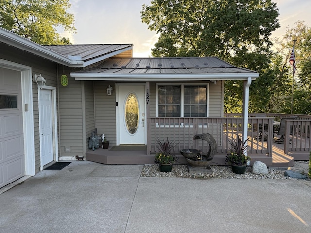 127 S Front St, Hennepin, IL 61327 - view of exterior entry with a metal roof, a porch, and a standing seam roof