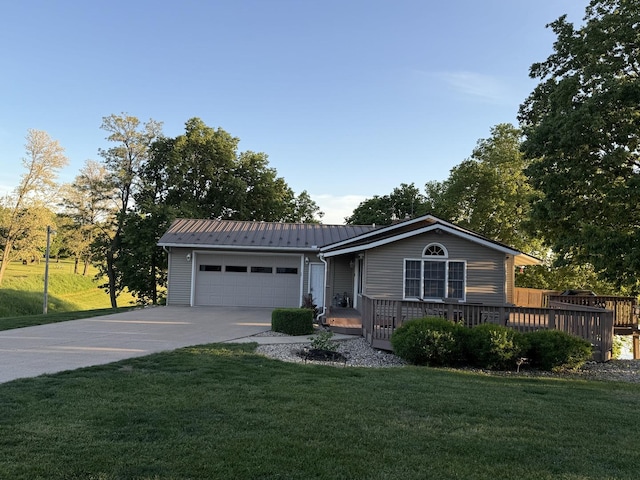 127 S Front St, Hennepin, IL 61327 - single story home featuring a garage, driveway, a metal roof, a front lawn, and a deck