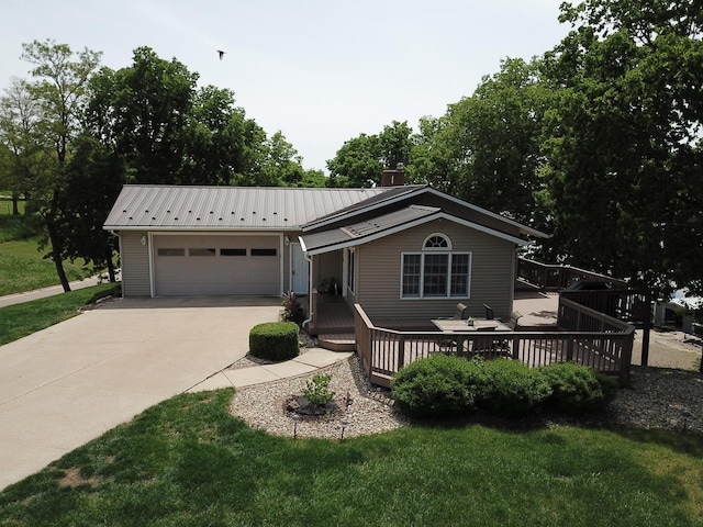 127 S Front St, Hennepin, IL 61327 - ranch-style home featuring driveway, a metal roof, a deck, an attached garage, and a front lawn