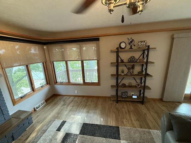 127 S Front St, Hennepin, IL 61327 - unfurnished living room with wood finished floors and a chandelier
