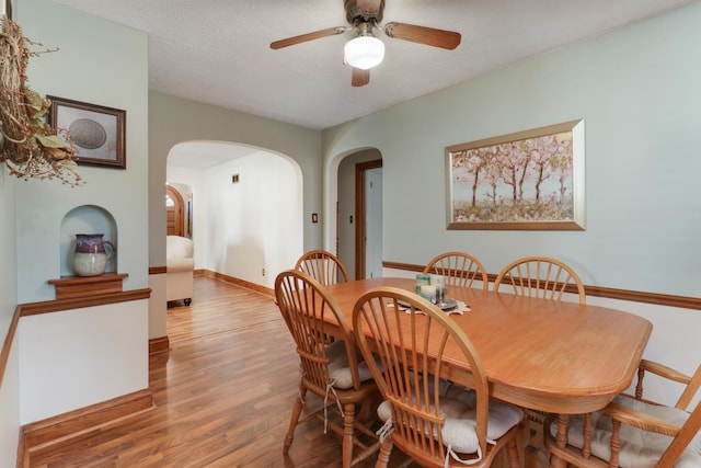 1211 Hovey Ave, Normal, IL 61761 - dining area with arched walkways, wood finished floors, and ceiling fan