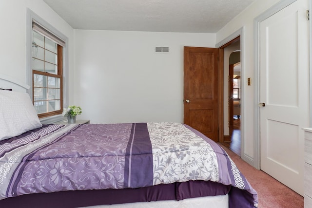 1211 Hovey Ave, Normal, IL 61761 - bedroom with carpet flooring and arched walkways