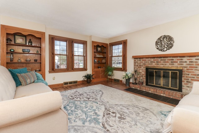 1211 Hovey Ave, Normal, IL 61761 - living area with wood finished floors and a brick fireplace