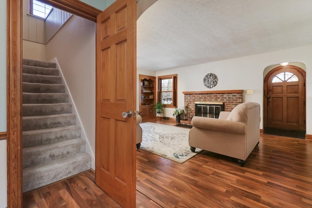 1211 Hovey Ave, Normal, IL 61761 - living area featuring stairs, wood finished floors, arched walkways, plenty of natural light, and a textured ceiling
