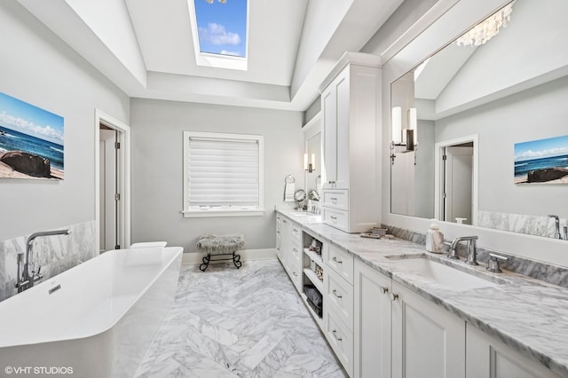 4845 N Leavitt St, Chicago, IL 60625 - full bathroom featuring double vanity, marble look tile flooring, a skylight, a freestanding tub, and vaulted ceiling