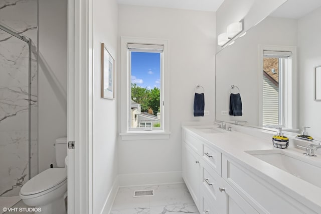 4845 N Leavitt St, Chicago, IL 60625 - bathroom with marble finish floors, a marble finish shower, double vanity, and healthy amount of natural light