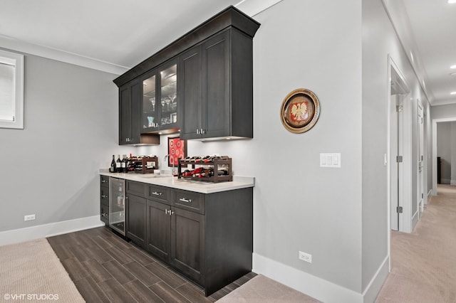 4845 N Leavitt St, Chicago, IL 60625 - indoor bar featuring wine cooler, ornamental molding, and dark wood-type flooring