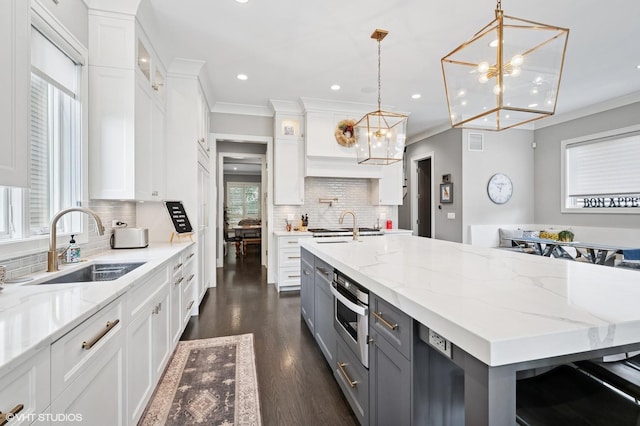 4845 N Leavitt St, Chicago, IL 60625 - kitchen featuring a chandelier, gray cabinets, white cabinets, recessed lighting, and decorative backsplash