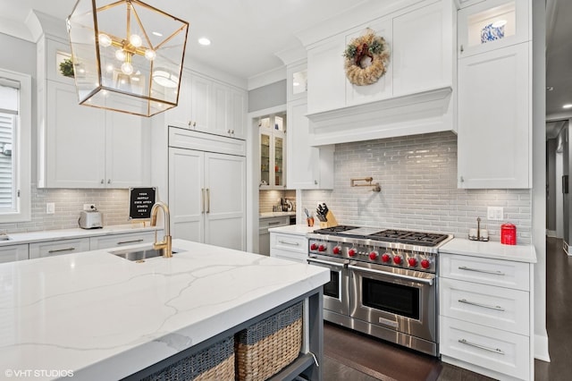 4845 N Leavitt St, Chicago, IL 60625 - kitchen featuring high quality appliances, decorative backsplash, white cabinetry, a chandelier, and recessed lighting