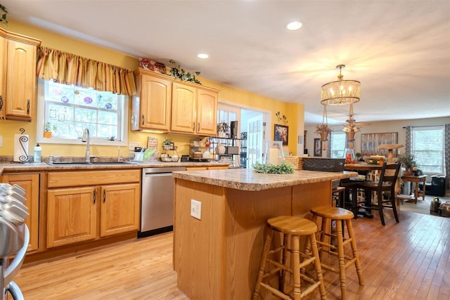 2321 Hayden Way, Normal, IL 61761 - kitchen featuring stainless steel dishwasher, a kitchen bar, a center island, light wood-style floors, and recessed lighting