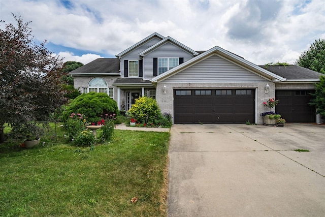 2321 Hayden Way, Normal, IL 61761 - traditional-style home featuring concrete driveway, a front yard, a garage, and brick siding