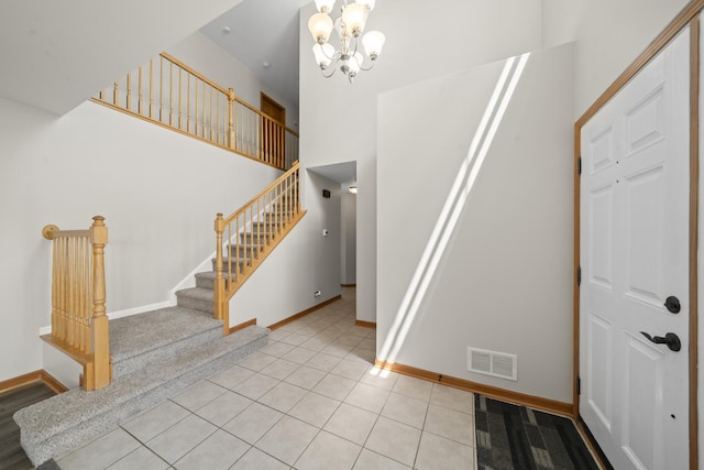 940 Hyte St, Plano, IL 60545 - entryway with stairway, a chandelier, a high ceiling, and tile patterned floors