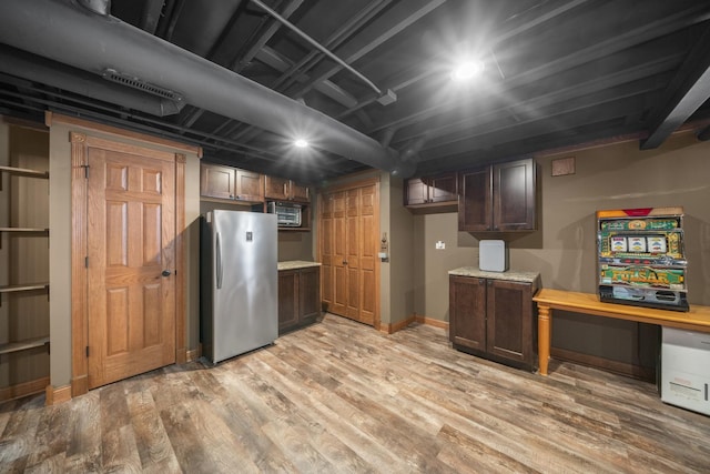 940 Hyte St, Plano, IL 60545 - finished below grade area with freestanding refrigerator and light wood-type flooring