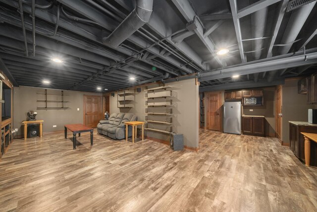 940 Hyte St, Plano, IL 60545 - finished basement featuring freestanding refrigerator and light wood-style floors