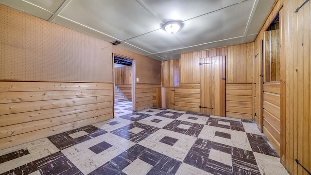 2408 Colorado Ave, Rockford, IL 61108 - empty room featuring tile patterned floors and wooden walls