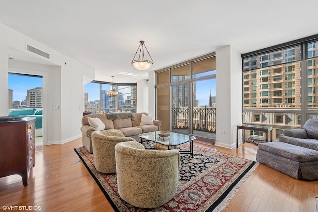21 E Huron St Unit 1407, Chicago, IL 60611 - living room featuring a view of city, light wood-style flooring, and a wall of windows