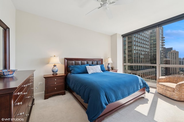 21 E Huron St Unit 1407, Chicago, IL 60611 - bedroom featuring light colored carpet, a city view, a wall of windows, and a ceiling fan