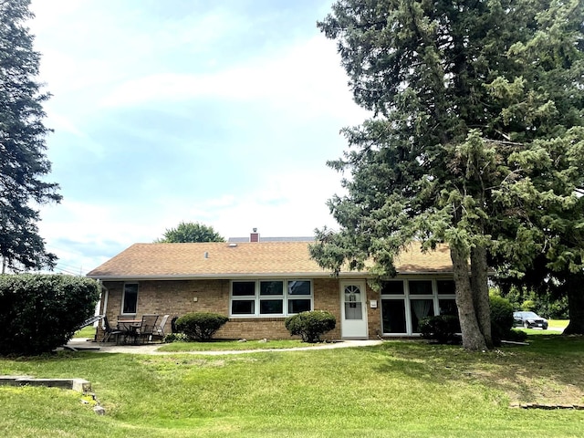 7401 W 113th Pl, Worth, IL 60482 - back of house featuring a yard, brick siding, a chimney, and a patio