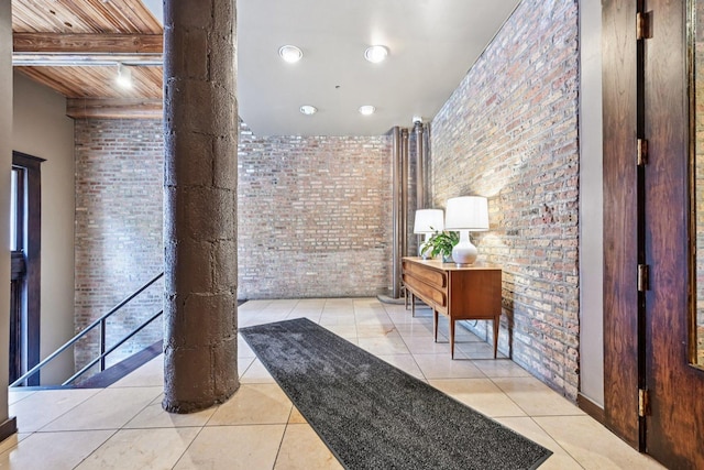 913 W Van Buren St Unit 5H, Chicago, IL 60607 - corridor featuring brick wall, tile patterned flooring, a wooden ceiling with exposed beams, and decorative columns