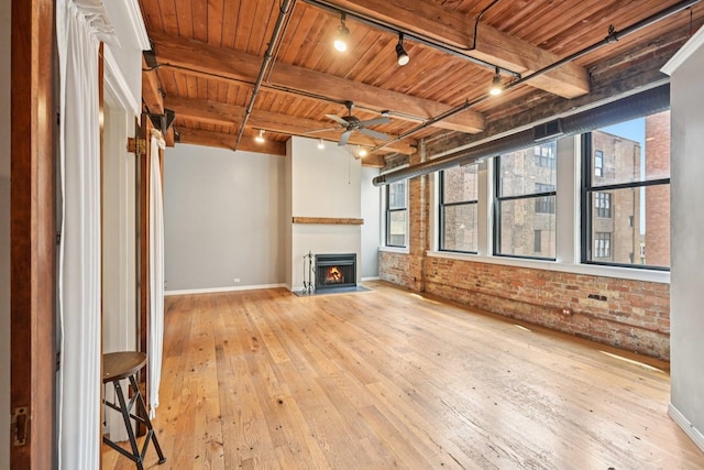 913 W Van Buren St Unit 5H, Chicago, IL 60607 - unfurnished living room featuring track lighting, a wooden ceiling with exposed beams, brick wall, wood-type flooring, and plenty of natural light