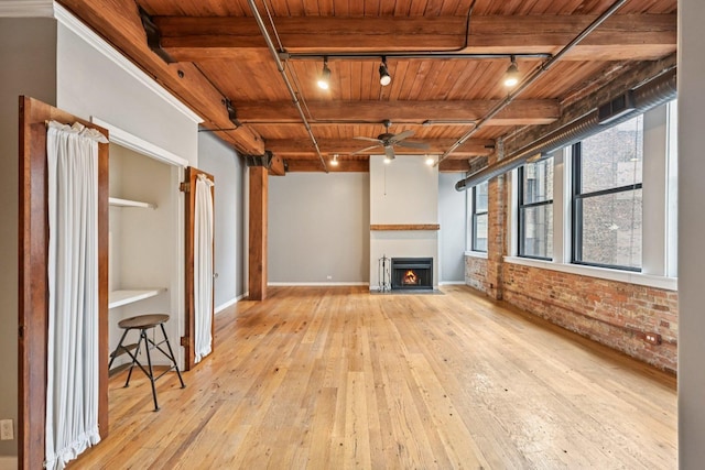 913 W Van Buren St Unit 5H, Chicago, IL 60607 - unfurnished living room with rail lighting, a wood ceiling with exposed beams, a ceiling fan, wood-type flooring, and brick wall