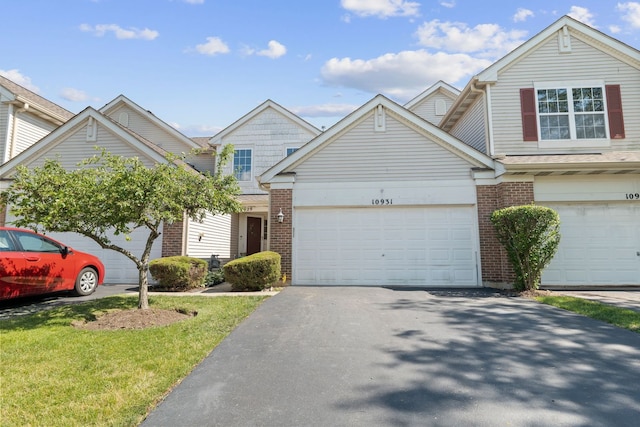 10931 Cape Cod Ln, Huntley, IL 60142 - view of front facade with brick siding, driveway, a garage, and a front yard