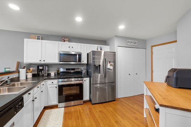 10931 Cape Cod Ln, Huntley, IL 60142 - kitchen with stainless steel appliances, white cabinets, light wood finished floors, butcher block countertops, and recessed lighting