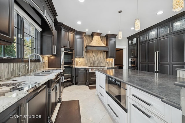 22 Westlake Dr, South Barrington, IL 60010 - kitchen with premium range hood, appliances with stainless steel finishes, tasteful backsplash, light tile patterned floors, and pendant lighting