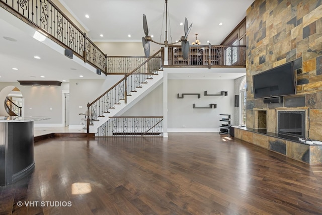 22 Westlake Dr, South Barrington, IL 60010 - unfurnished living room with a high ceiling, a tiled fireplace, a chandelier, wood finished floors, and stairs