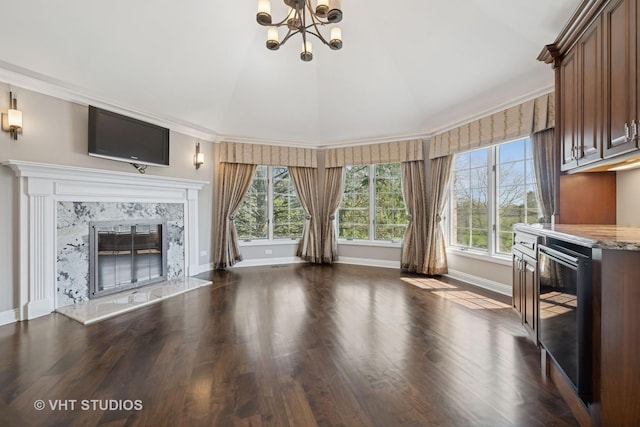 22 Westlake Dr, South Barrington, IL 60010 - unfurnished living room with healthy amount of natural light, dark wood-style floors, a chandelier, a premium fireplace, and vaulted ceiling